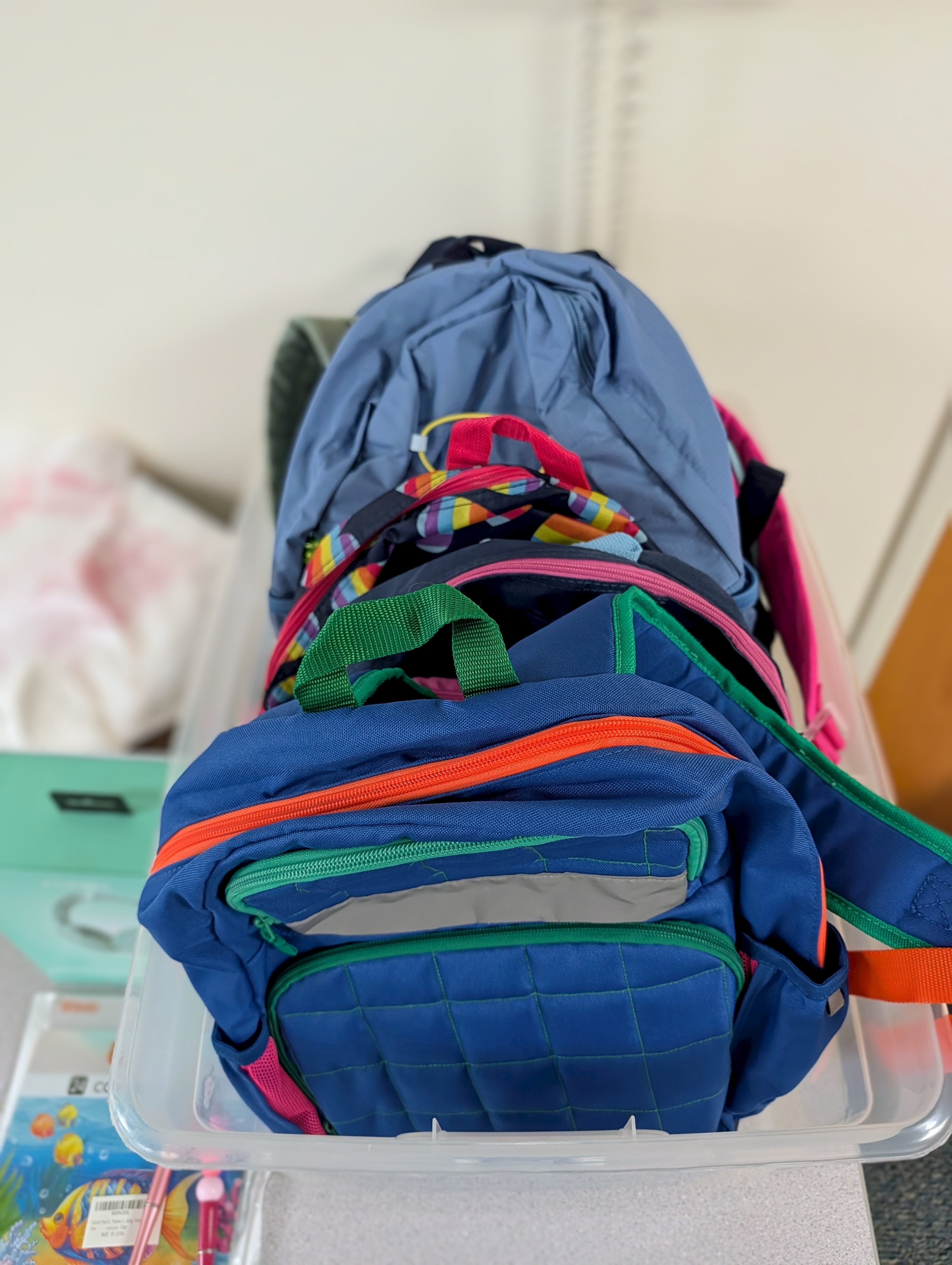 Colorful backpacks stacked and ready for kids