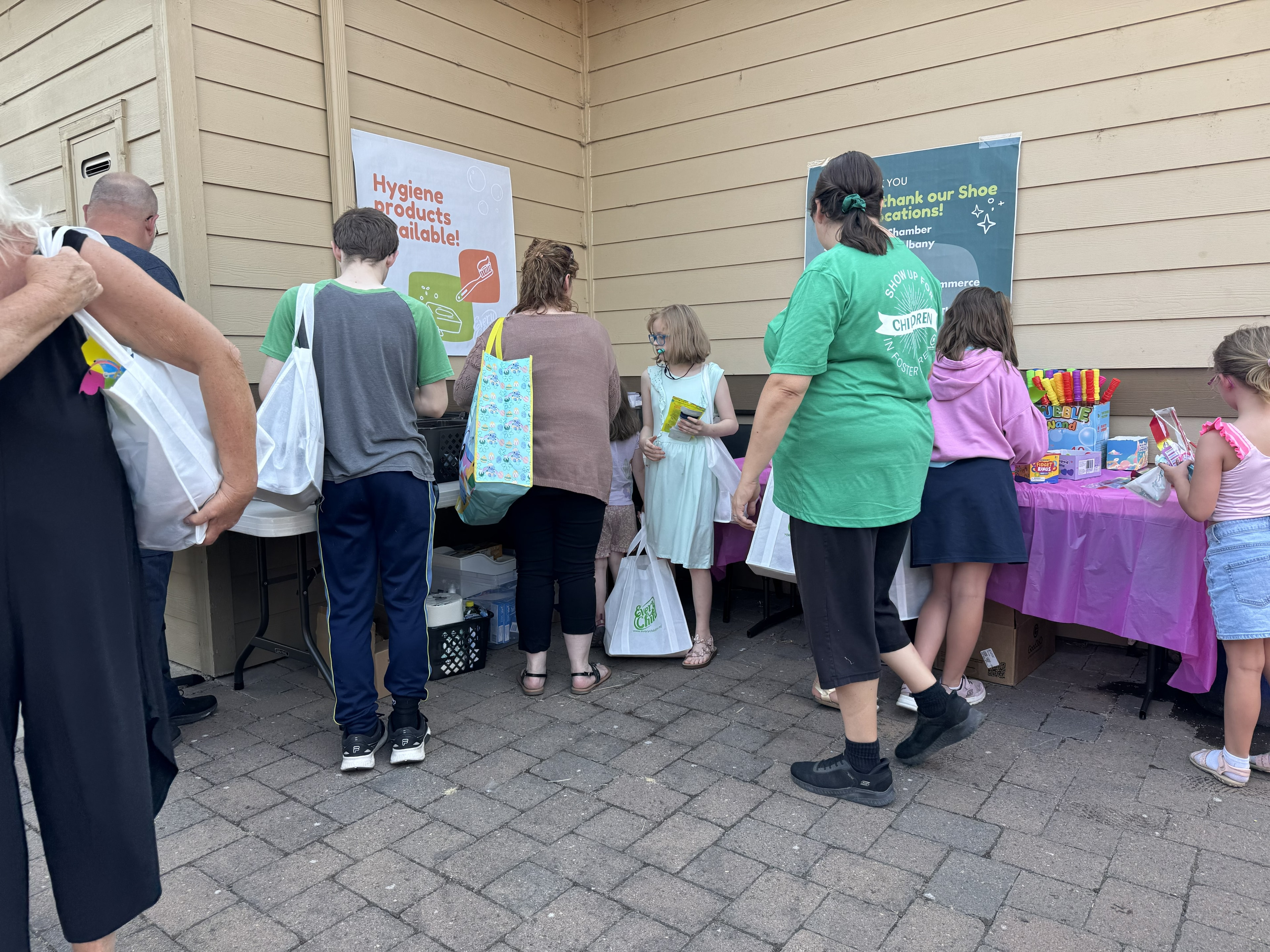 Families picking up hygiene products at the event