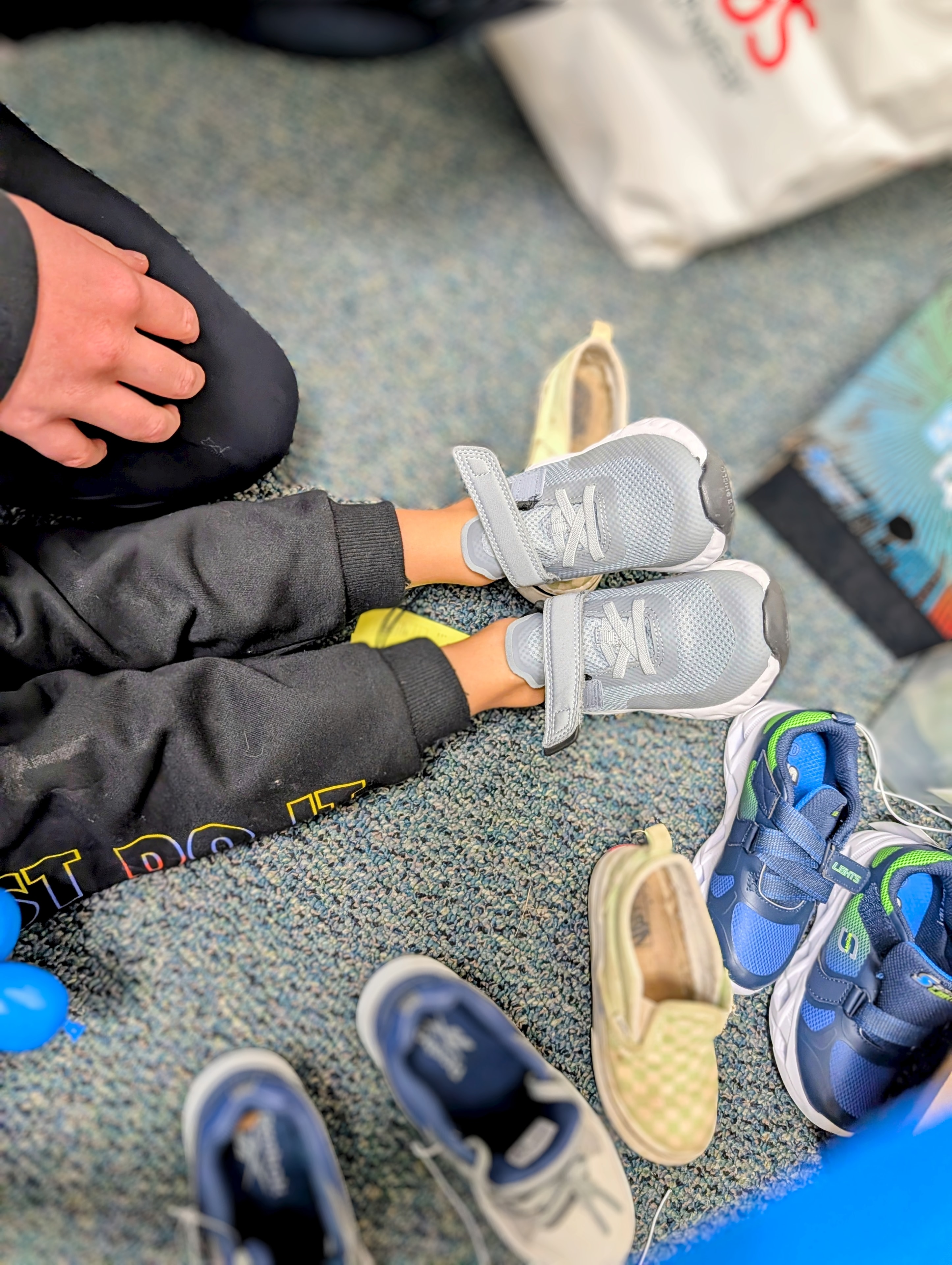 Child trying on new shoes at the event