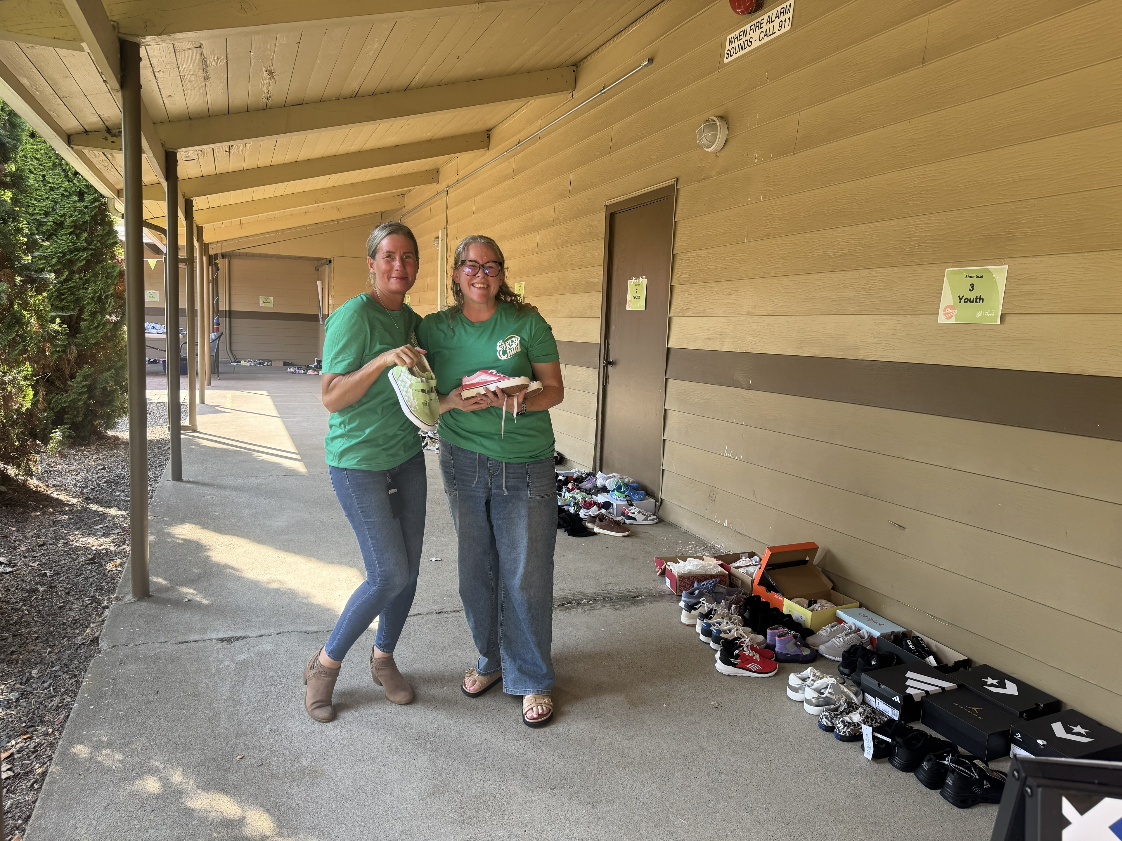 Volunteers sorting donated shoes outside